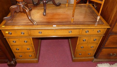 Lot 1266 - A Victorian oak and tan leather inset twin...