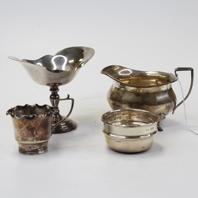 Lot 302 - A George V silver milk jug, of squat fluted...