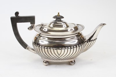 Lot 313 - A George V silver teapot, of half-fluted bombe...