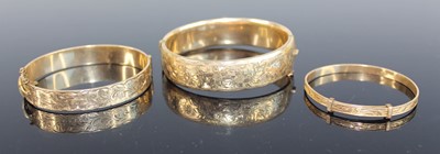 Lot 370 - A Victorian style rolled gold hinged bangle,...