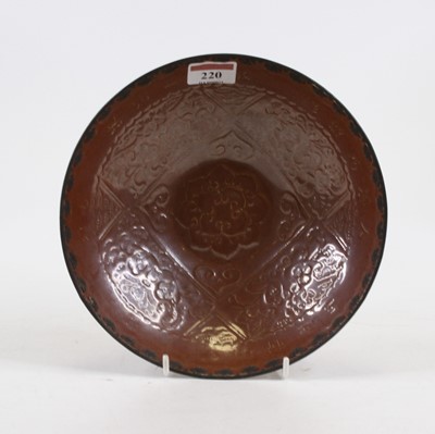 Lot 220 - A Chinese brown glazed bowl, having a white...