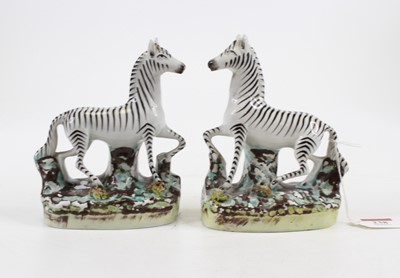 Lot 238 - A pair of Staffordshire pottery models of...