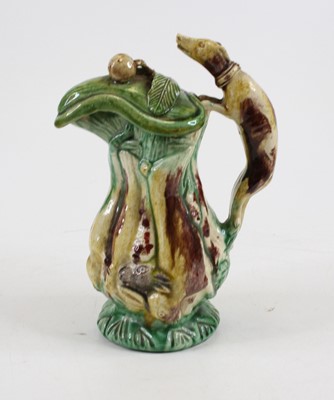 Lot 253 - A majolica hunting jug, the handle in the form...