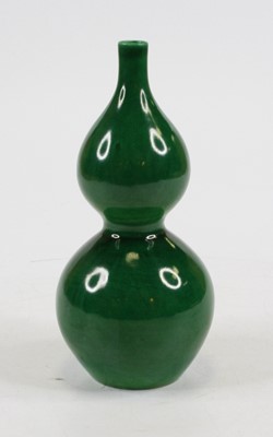 Lot 256 - A Chinese green glazed porcelain double gourd...