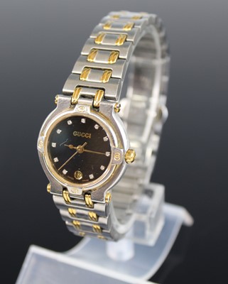 Lot 376 - A lady's Gucci bi-metal quartz bracelet watch,...