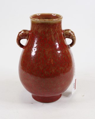 Lot 259 - A Chinese Hu vase, having a red mottled glaze...