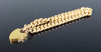 Lot 381 - A 9ct gold hollow curblink bracelet, on heart...