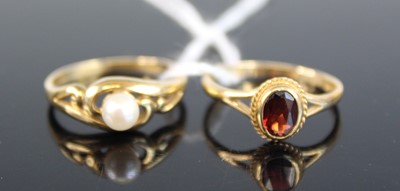 Lot 387 - A 9ct gold garnet set dress ring, sponsor BKT,...