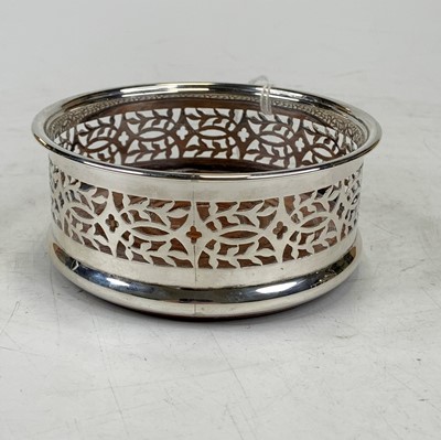 Lot 458 - A modern silver bottle coaster, of pierced...