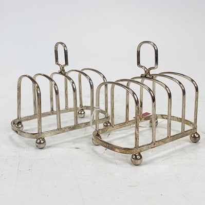 Lot 459 - A matched pair of silver toast racks, each...