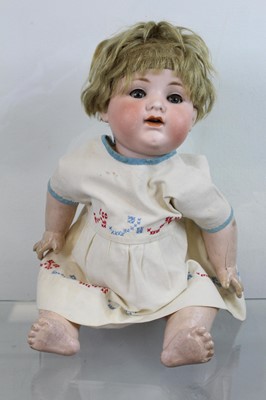 Lot 560 - A bisque headed doll, having brown glass eyes,...