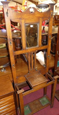 Lot 1303 - An early 20th century oak mirrorback hallstand,...