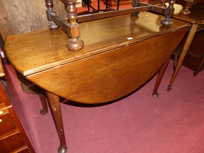 Lot 1354 - A 19th century provincial oak dropleaf dining...