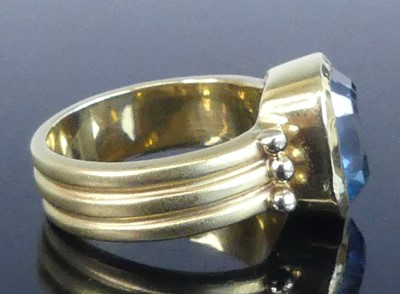 Lot 2546 - A yellow metal blue topaz heavy dress ring,...
