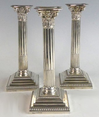 Lot 2109 - A set of three Victorian silver candlesticks,...