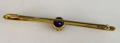 Lot 2554 - A yellow metal amethyst bar brooch, having a...