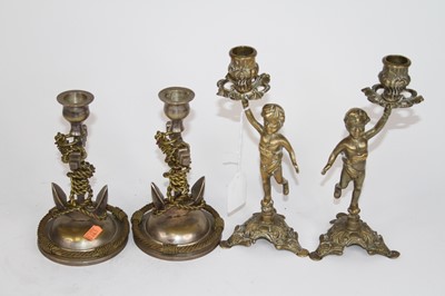 Lot 27 - A pair of figural brass table candlesticks,...