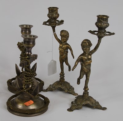 Lot 27 - A pair of figural brass table candlesticks,...