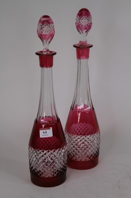 Lot 64 - A pair of cut cranberry and clear glass...