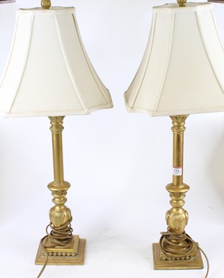 Lot 121 - A pair of gilt table lamps with shades, each h....