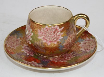 Lot 216 - A Japanese teacup and saucer, enamel and gilt...