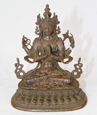 Lot 220 - A bronzed figure of a Tibetan deity, height 10....