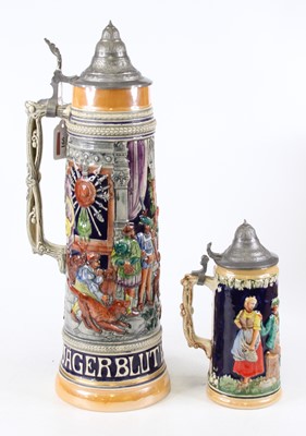 Lot 166 - A German pottery beerstein, relief decorated...