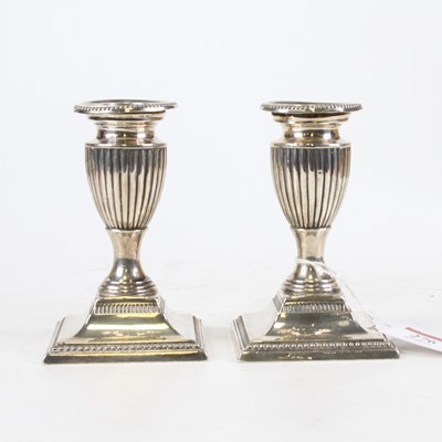 Lot 276 - A pair of George V silver table candlesticks,...