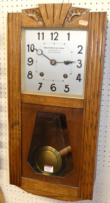 Lot 1127 - An Art Deco oak drop trunk wall clock, by...