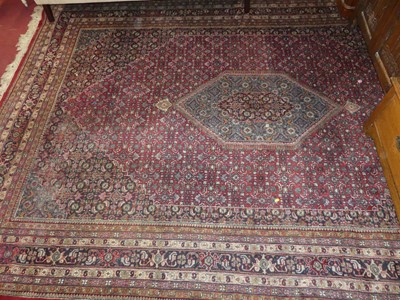 Lot 1140 - A Persian woollen red ground Shiraz rug,...