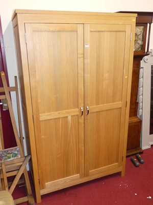 Lot 1150 - A contemporary double door wardrobe, width 117cm