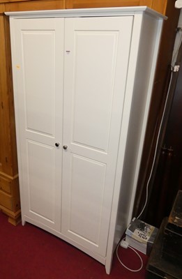 Lot 1154 - A contemporary white wood double door wardrobe,...