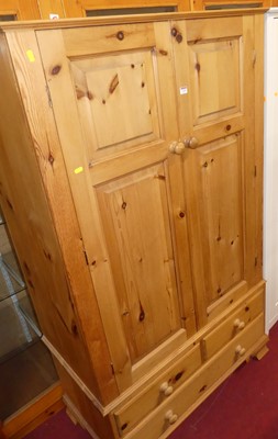 Lot 1155 - A contemporary pine double door wardrobe,...