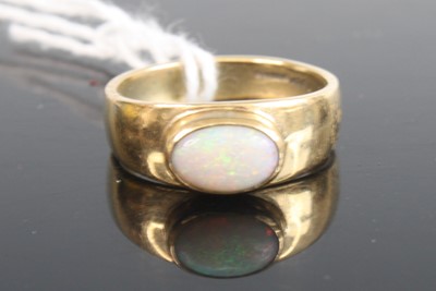 Lot 357 - A 9ct gold opal set band ring, 4.3g, size P/Q