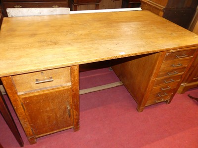 Lot 1173 - A 1930s oak kneehole writing desk, one...