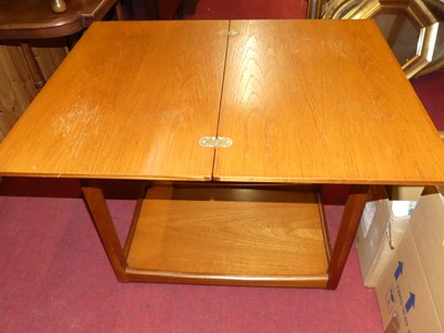 Lot 1176 - A 1970s teak folding two-tier tea trolley,...