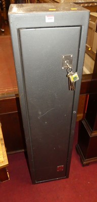 Lot 1185 - A steel freestanding gun cabinet with keys,...