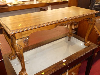 Lot 1188 - A walnut rectangular coffee table, having a...