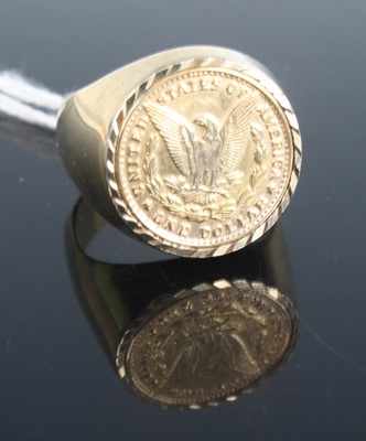 Lot 364 - A gilt metal sovereign type ring containing a...