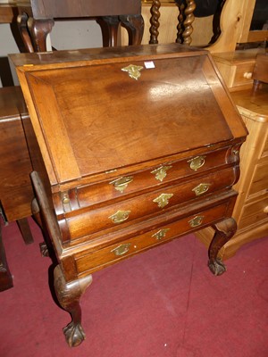 Lot 1192 - A mahogany slopefront bureau on stand, the...