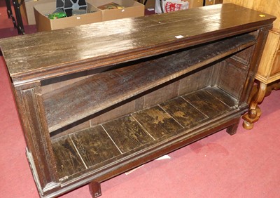 Lot 1203 - A stained oak low open bookshelf, raised on...