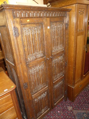 Lot 1228 - A joined oak linenfold panelled double door...