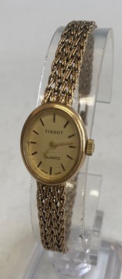 Lot 399 - A Tissot ladies 9ct gold cased bracelet watch...