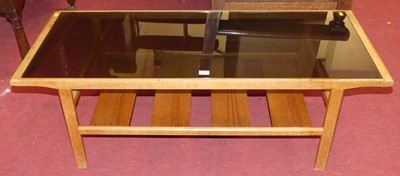 Lot 1253 - A 1970s teak and smoky glass inset two-tier...