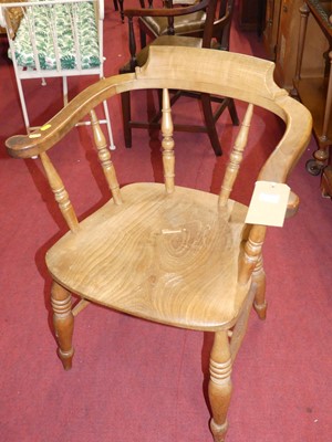 Lot 1278 - An early 20th century elm tub Captain's chair,...