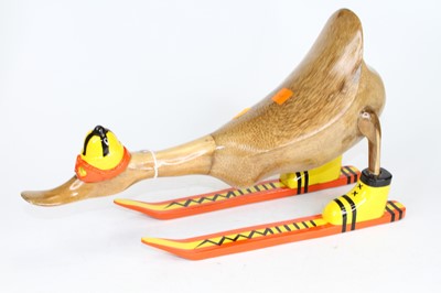 Lot 472 - A novelty wood carving of a skiing duck,...