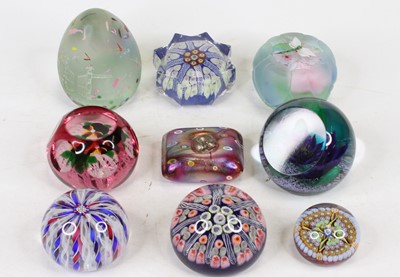 Lot 479 - A collection of glass paperweights to include...