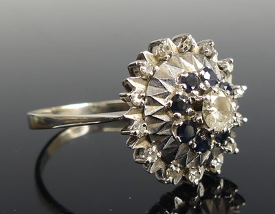 Lot 2608 - A white metal, sapphire and diamond reverse...