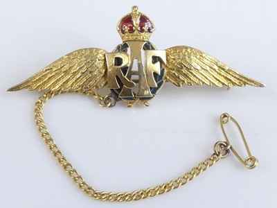 Lot 2639 - A yellow metal RAF wings brooch, the crown set...