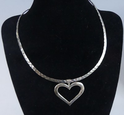 Lot 2640 - A contemporary silver collar with heart shaped...